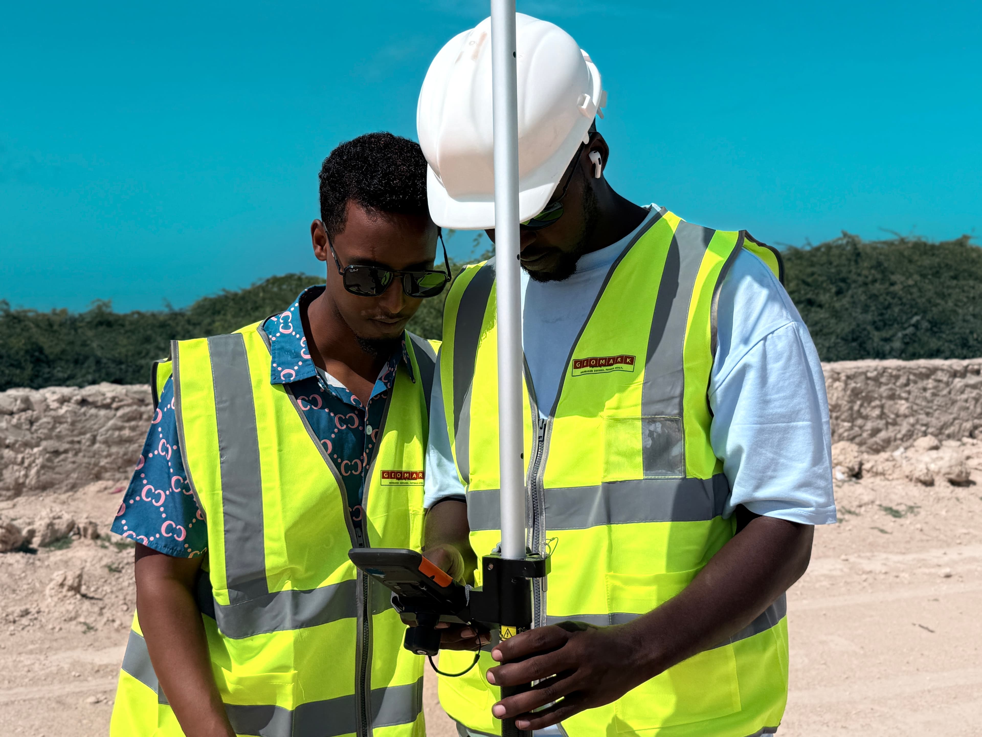 GEOMARK engineers reviewing GNSS survey data on the field