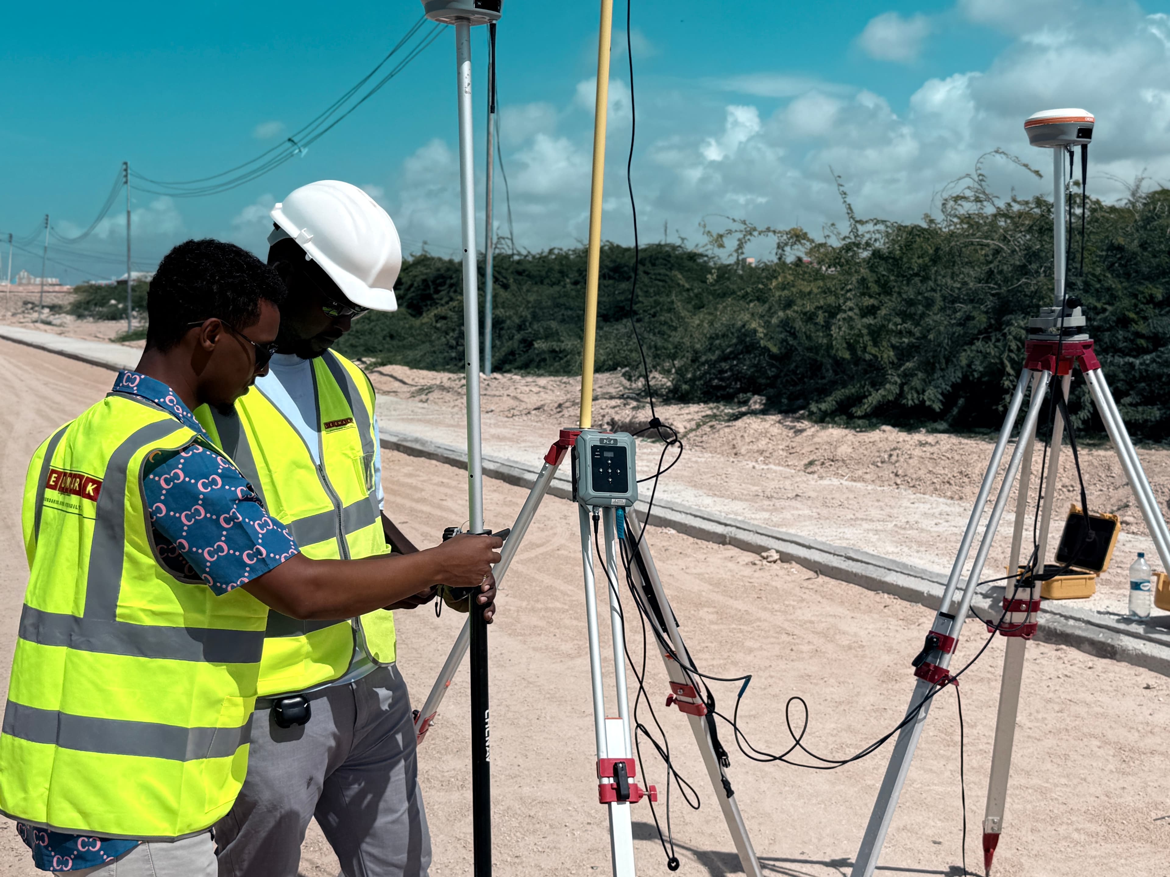 GEOMARK surveyors using GNSS equipment on a construction site in Somalia