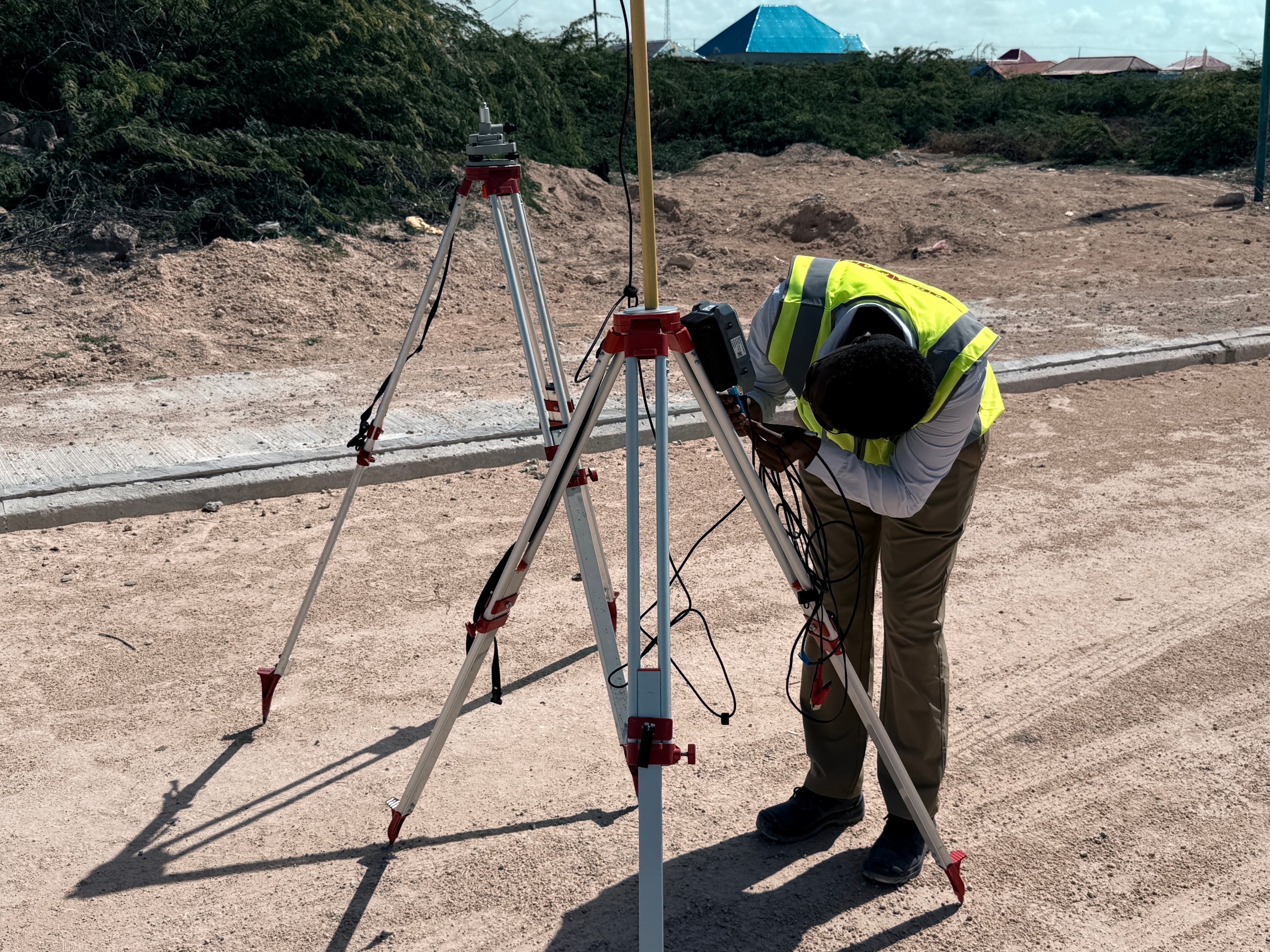 Engineer setting up GNSS RTK base station for road corridor control