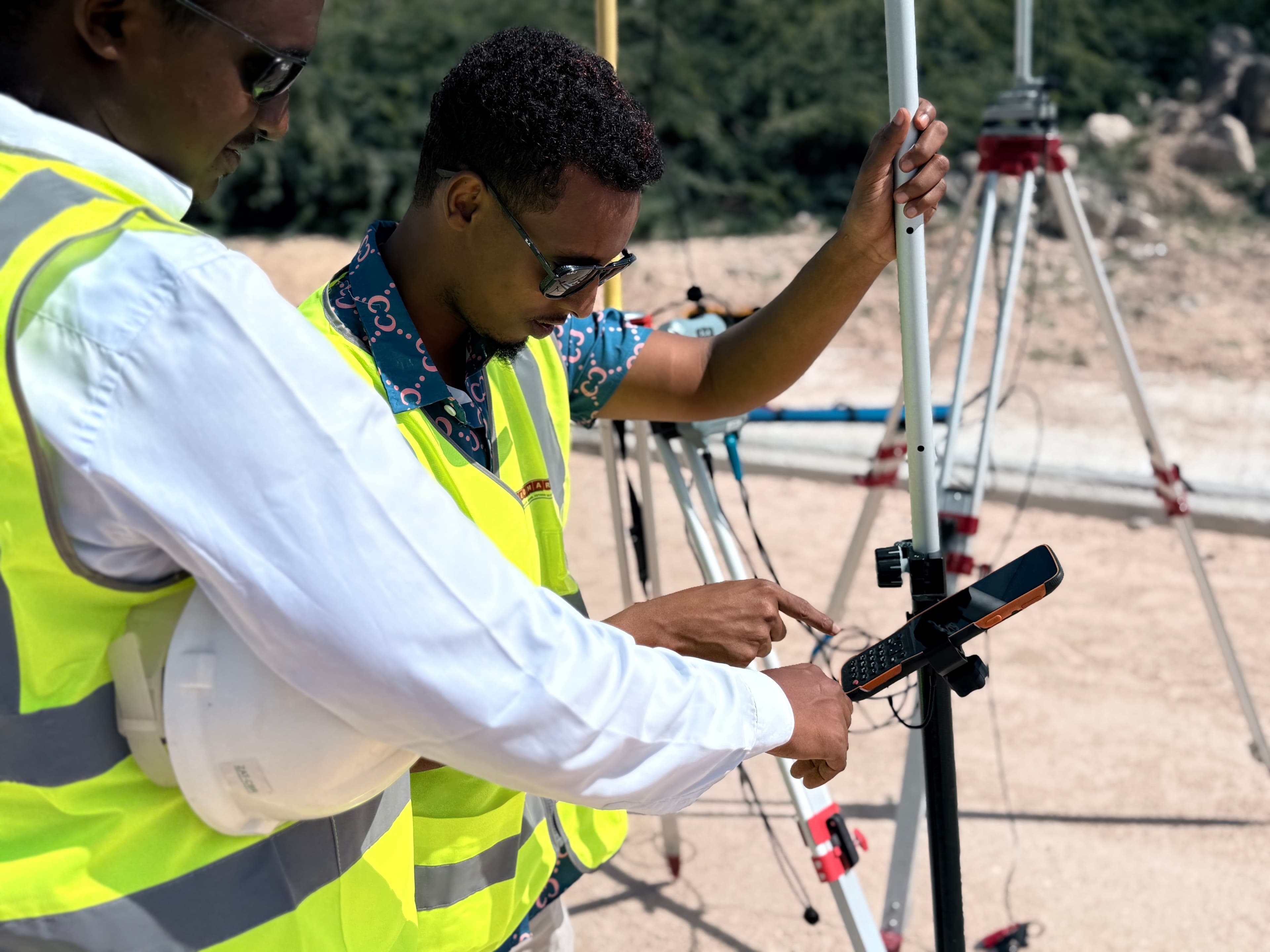 GEOMARK engineers reviewing survey data on field data controller